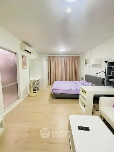 Spacious modern bedroom with stylish decor and natural light