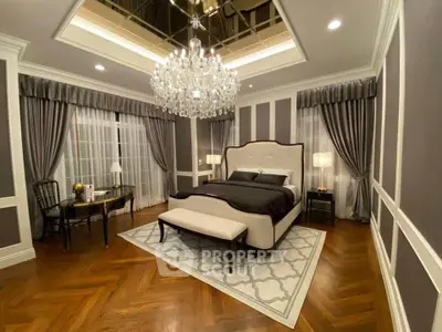 Luxurious bedroom with elegant chandelier and stylish decor