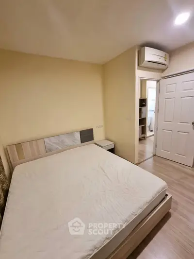 Cozy bedroom with modern furnishings and air conditioning in a stylish apartment.