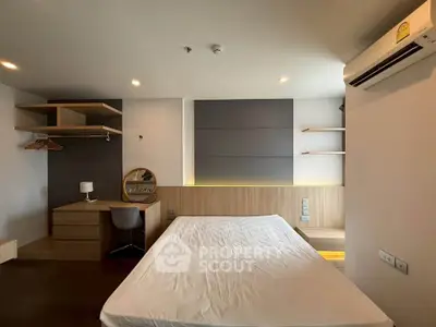 Modern bedroom with built-in desk and shelves, featuring minimalist design and ambient lighting.