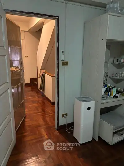 Cozy interior with wooden flooring and modern air purifier in hallway