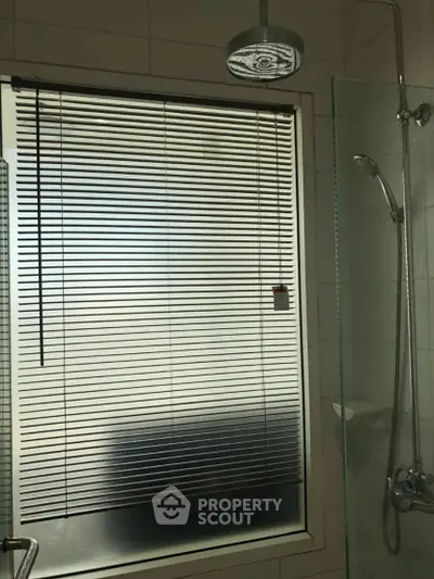 Modern bathroom with sleek shower and window blinds