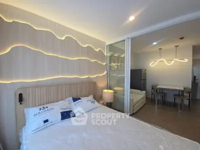 Modern bedroom with stylish lighting and open layout in a contemporary apartment.