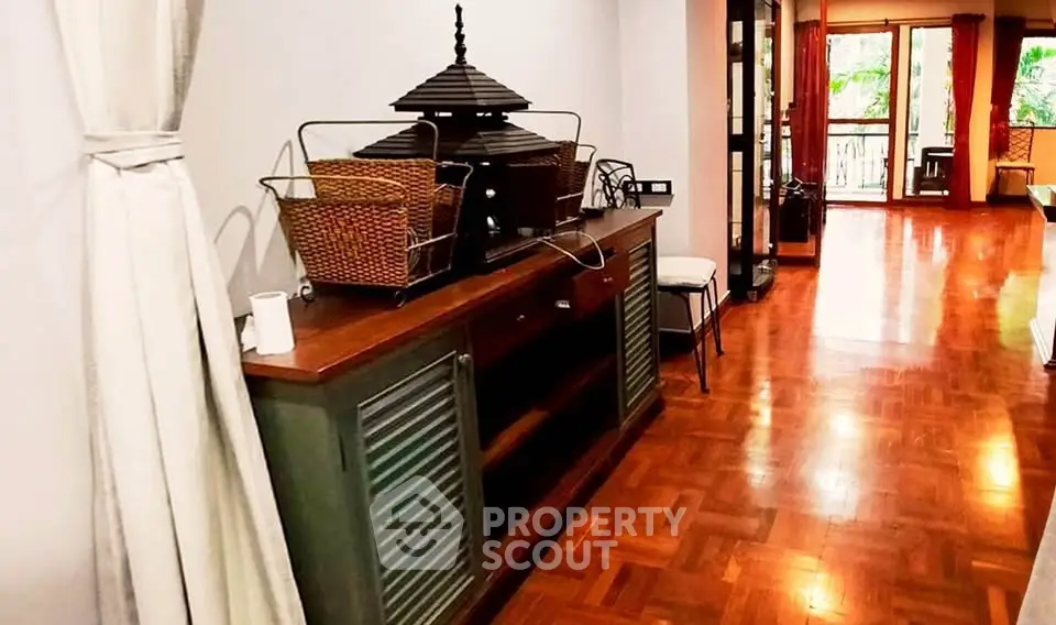 Spacious living area with wooden flooring and elegant decor