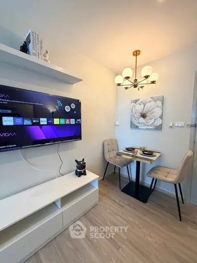 Modern living room with stylish dining area and wall-mounted TV, perfect for cozy urban living.