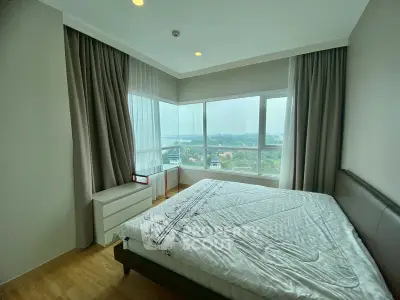Spacious bedroom with large windows offering stunning views of the cityscape and natural surroundings.
