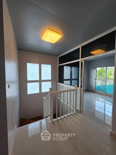 Modern interior stairway with glass walls and natural light
