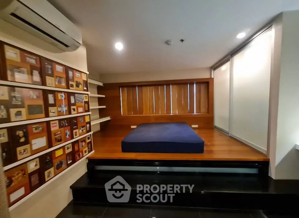 Modern bedroom with elevated platform bed and stylish wall decor