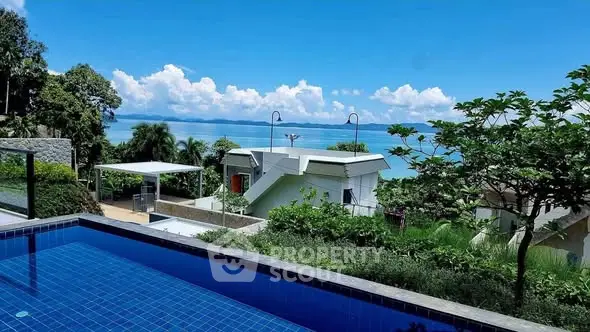 Stunning ocean view from a luxurious property with private pool and lush greenery.