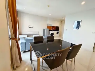 Modern open-plan living room with dining area and sleek furniture