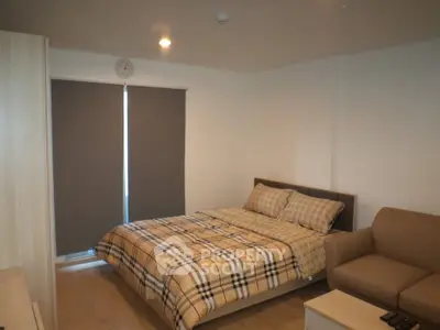 Cozy bedroom with modern decor and comfortable seating area