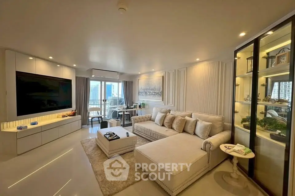 Luxurious living room with modern decor and city view, featuring a large sectional sofa and elegant lighting.