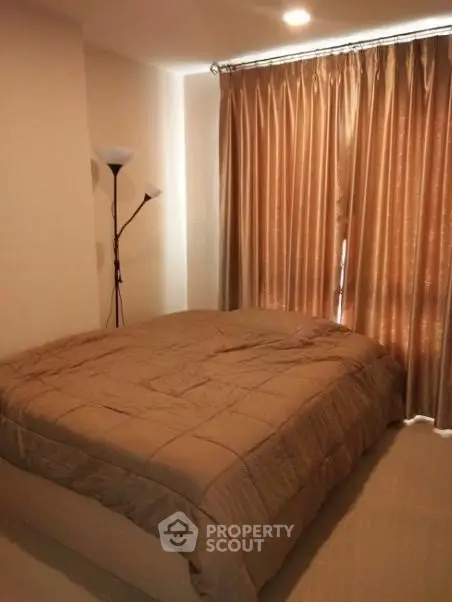 Cozy bedroom with warm lighting and elegant curtains, perfect for restful nights.