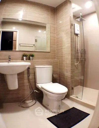 Modern bathroom with sleek fixtures and glass shower enclosure