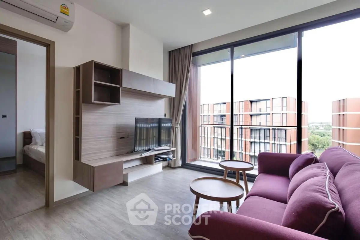 Modern living room with purple sofa and large windows offering a stunning view of the cityscape.