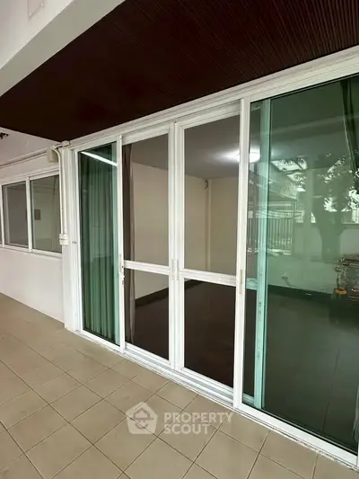 Spacious patio with sliding glass doors leading to a modern interior, perfect for indoor-outdoor living.