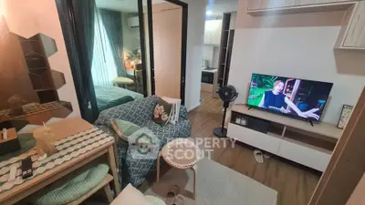 Cozy living room with modern decor and open view to bedroom