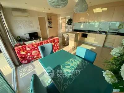 Modern open-layout kitchen and living area with stylish decor and natural light