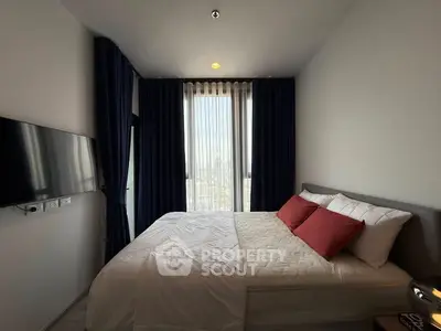 Modern bedroom with city view, featuring a cozy bed and stylish decor.