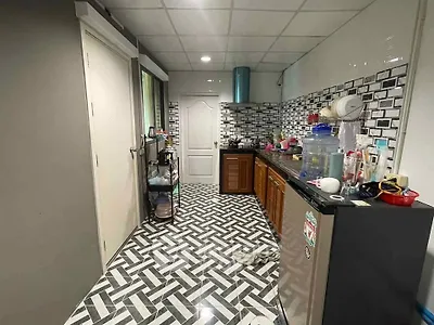 Modern kitchen with stylish geometric floor tiles and sleek cabinetry