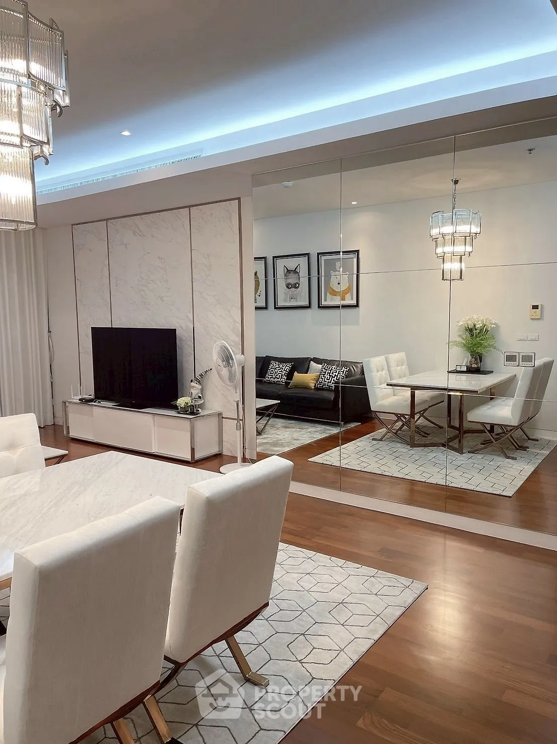 Luxurious modern living room with elegant dining area and mirrored wall