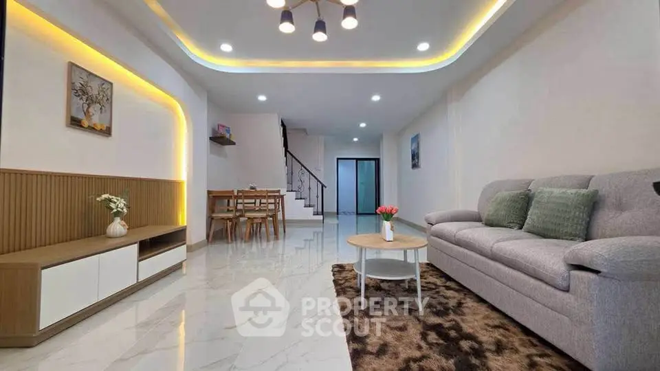Spacious modern living room with elegant lighting and stylish decor