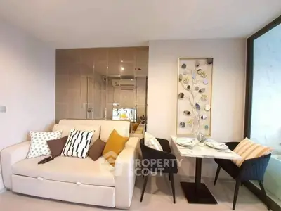 Modern living room with stylish decor and dining area in a cozy apartment.