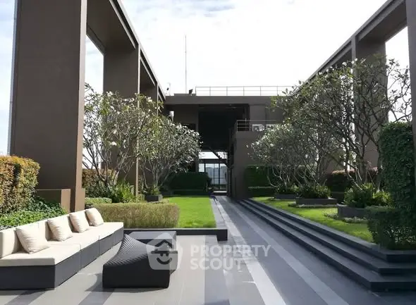 Luxurious rooftop garden with modern seating and lush greenery, perfect for relaxation and entertainment.