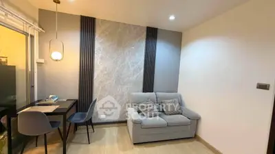 Modern living room with cozy sofa and dining area, featuring elegant lighting and stylish decor.