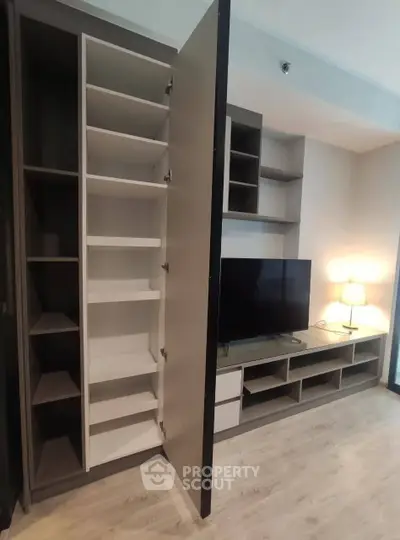 Modern living room with built-in storage and TV unit, perfect for urban living.