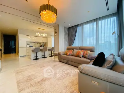 Luxurious modern living room with open kitchen and elegant chandelier
