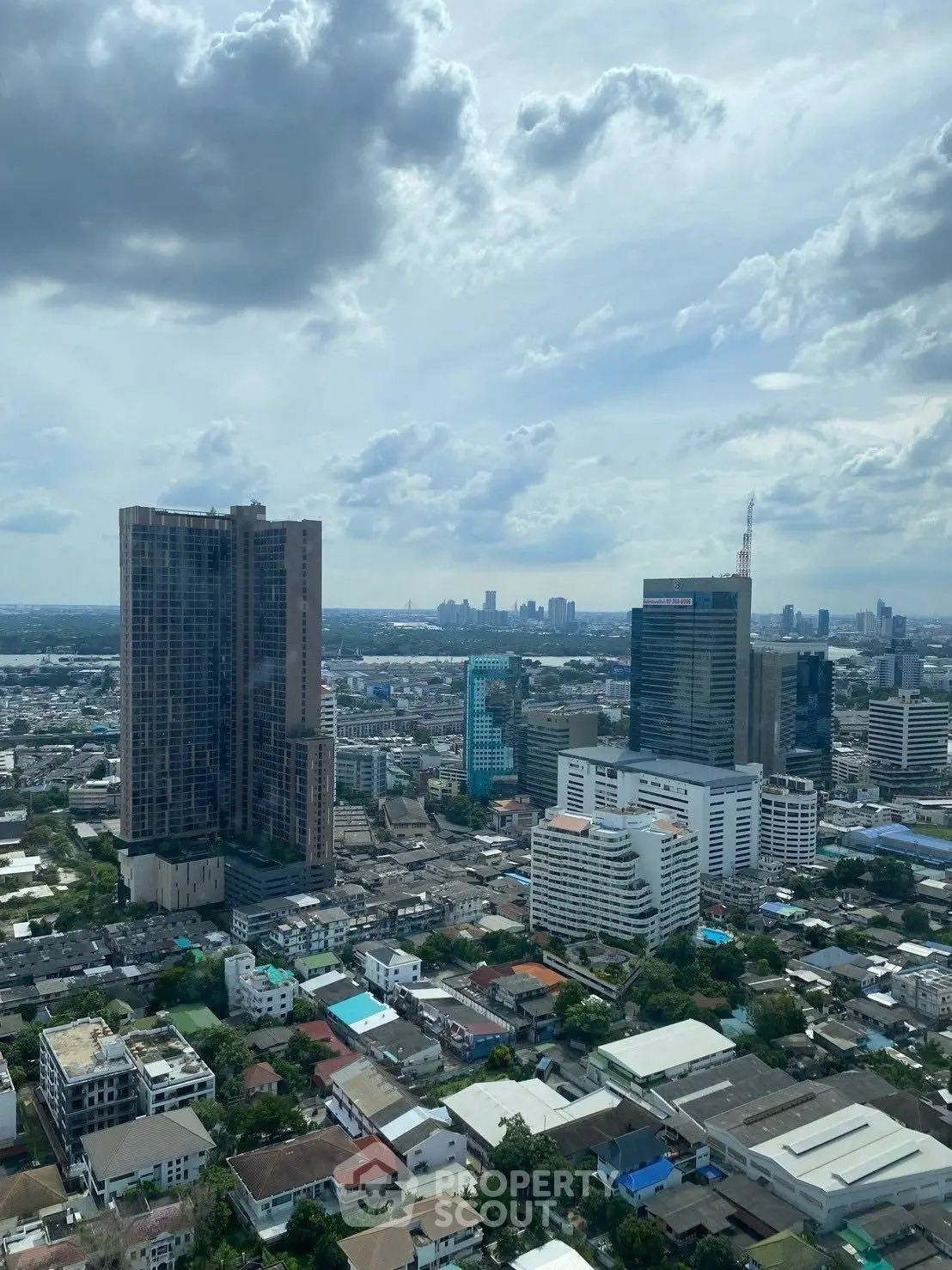 Stunning cityscape view showcasing high-rise buildings and urban landscape under a cloudy sky.