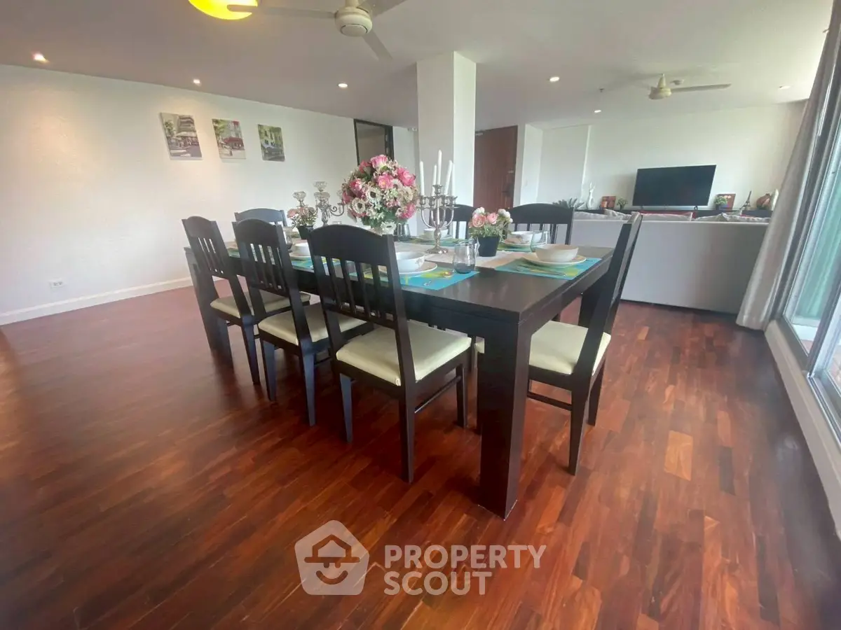 Spacious dining area with elegant wooden flooring and modern decor