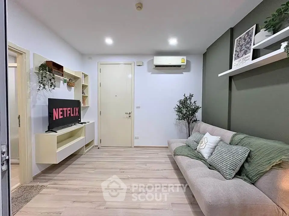 Modern living room with stylish decor and wall-mounted TV, perfect for relaxation and entertainment.