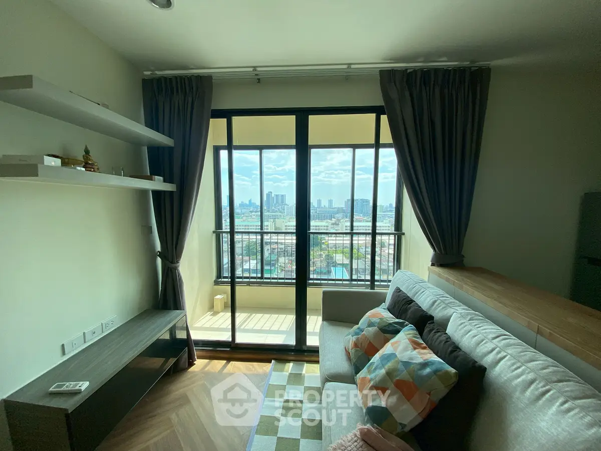 Modern living room with city view and balcony access, featuring stylish decor and natural light.