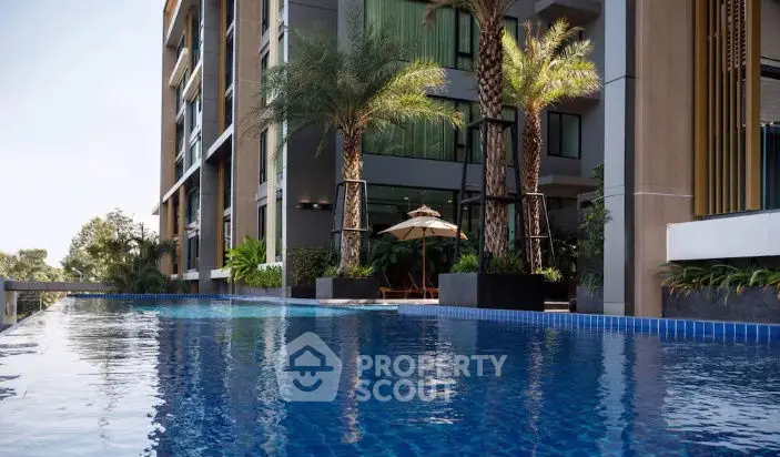 Luxurious apartment complex with stunning pool and palm trees
