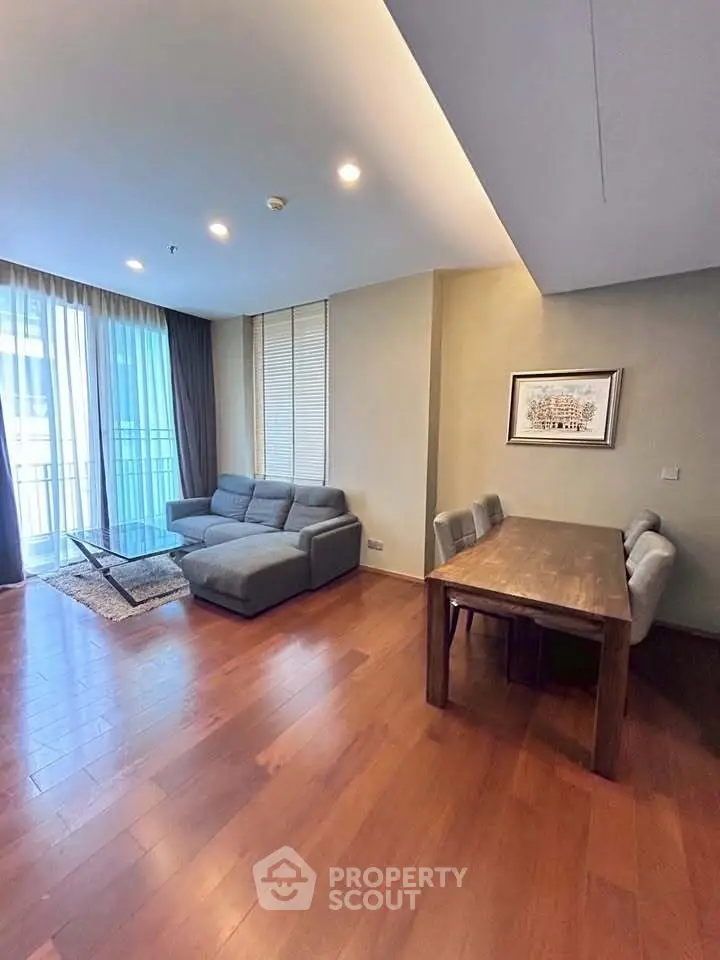 Spacious living room with modern furniture and large windows in a stylish apartment.