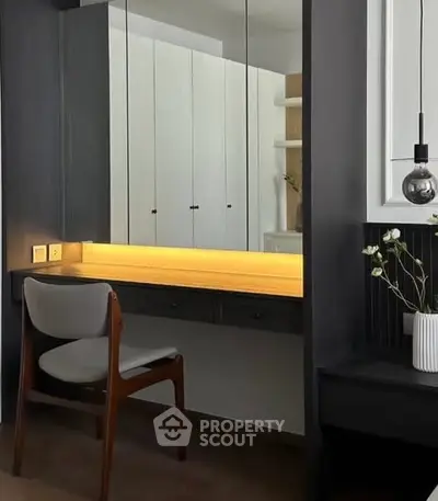 Modern study nook with sleek black cabinetry and warm lighting