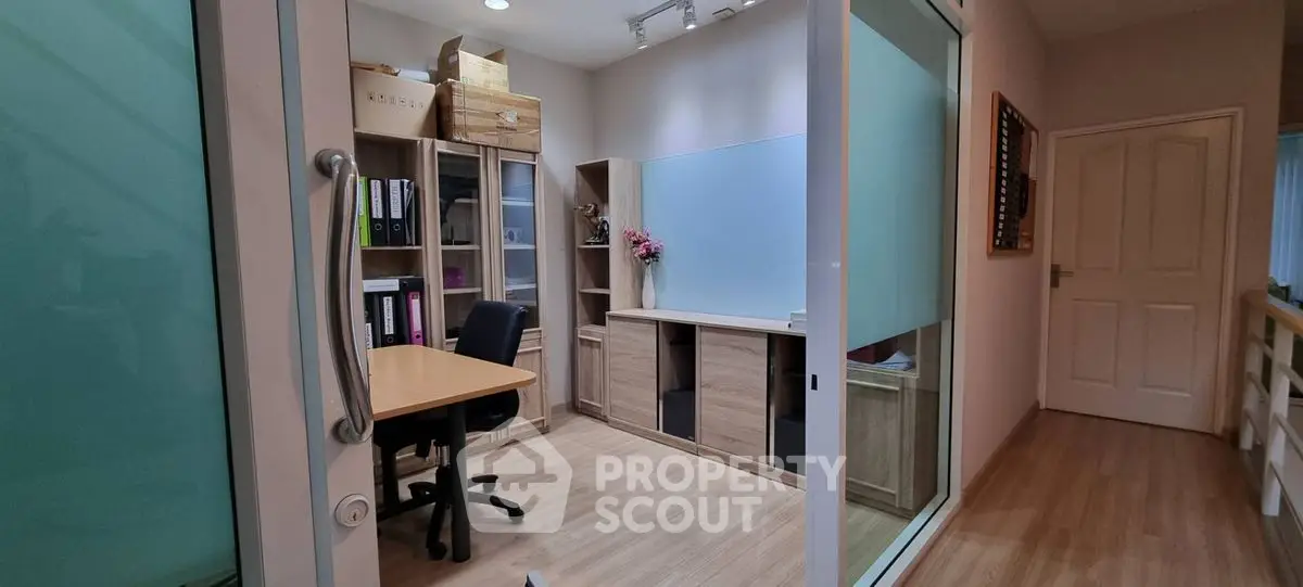 Modern home office with wooden flooring and ample storage space