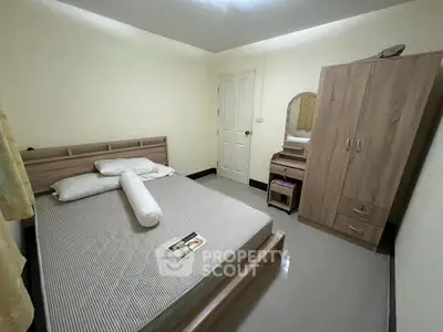 Cozy bedroom with modern wooden furniture and neutral decor, perfect for relaxation.