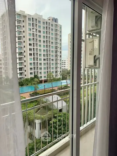 Modern apartment balcony with pool and garden view in urban setting