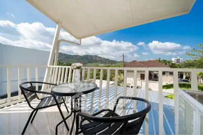 Charming balcony with scenic mountain views, perfect for relaxation and outdoor dining.