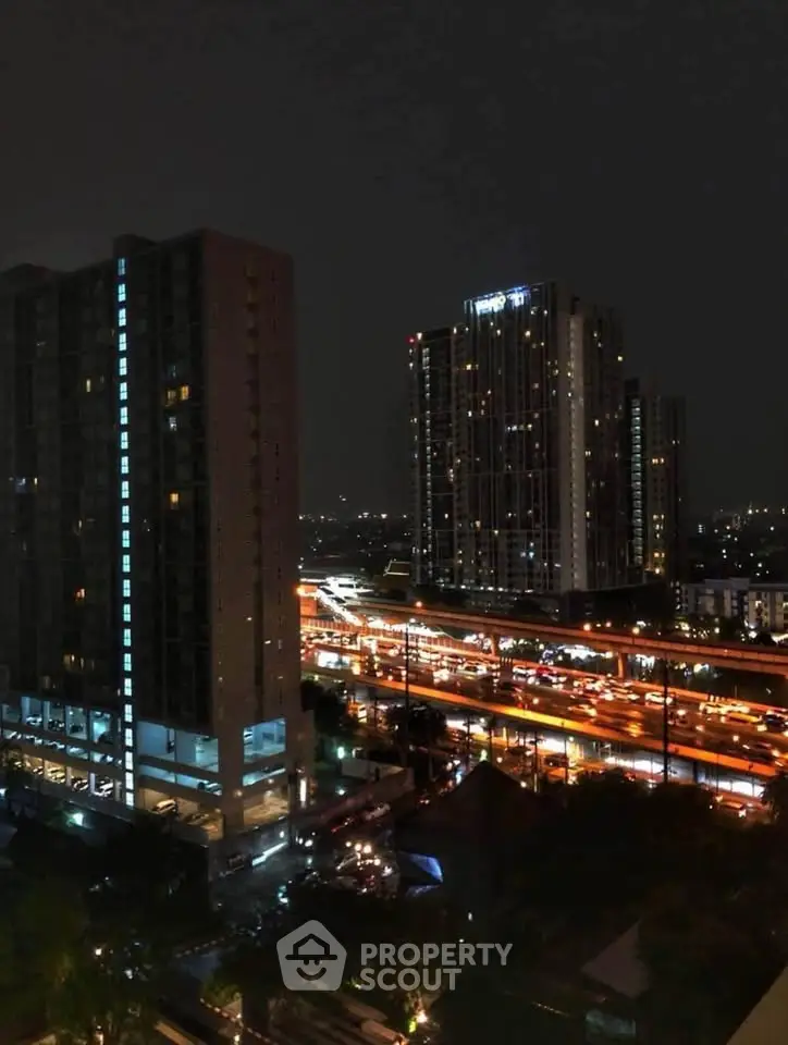 Stunning night view of cityscape with illuminated high-rise buildings and bustling highway.