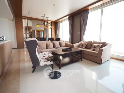 Spacious modern living room with elegant sofa and large windows