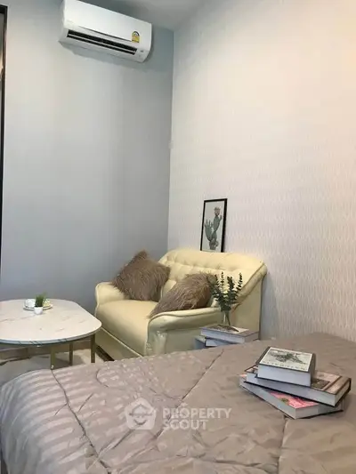 Cozy bedroom with stylish decor and air conditioning, perfect for relaxation.