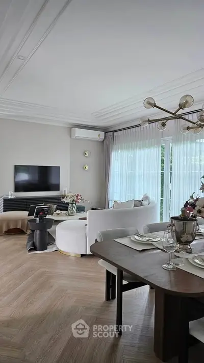 Elegant living room with modern decor and large windows