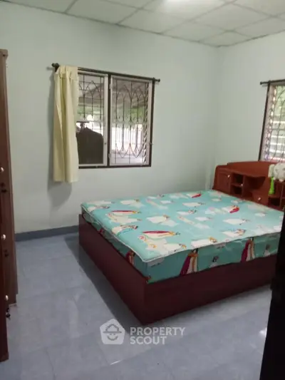 Cozy bedroom with simple furnishings and natural light