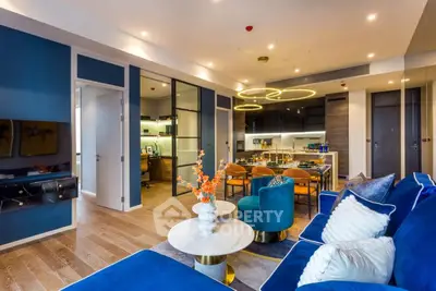 Luxurious modern living room with elegant blue decor and open kitchen layout