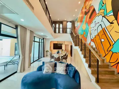 Stunning modern living room with vibrant mural and elegant furnishings in a luxurious open-plan design.
