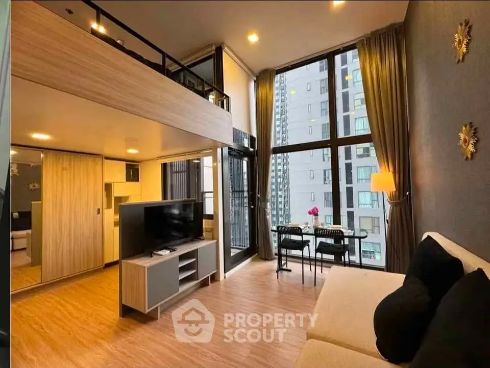 Modern loft-style living room with high ceilings and large windows in urban apartment